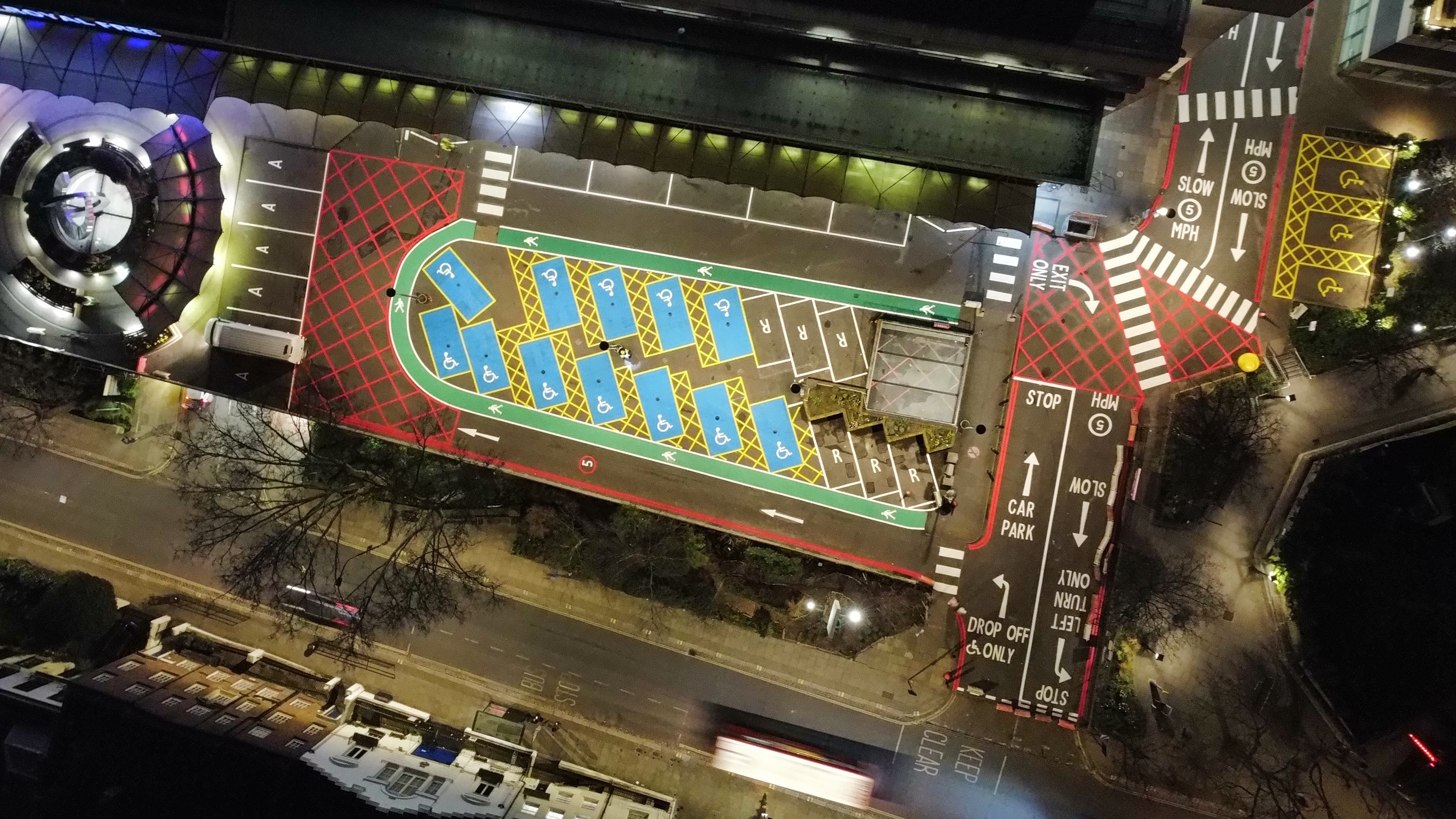 Aerial night shot — road markings, no-entry, loading bay, and pedestrian crossing, London